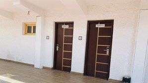 A hallway with two doors labeled "ROOM NO 102" and "ROOM NO 103". - SIT Ladakh Horizon  (Leh)