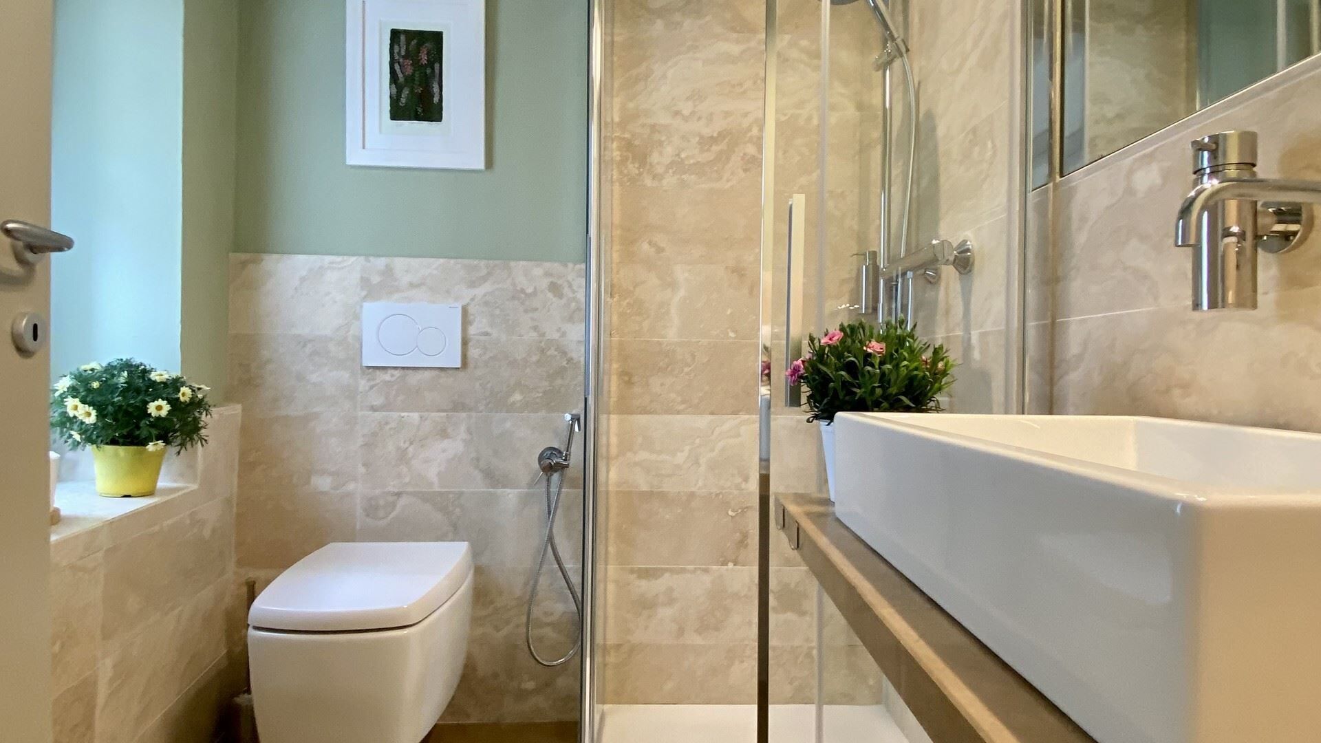 A bathroom with a shower, toilet, and sink.