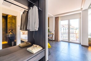 A modern hotel room with a large window, a balcony, and a view of the city. - Dei Martiri Suite (Naples)