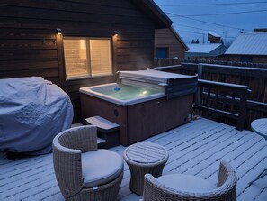 A wooden deck with a hot tub, covered seating, and a covered table. - The Little Lodge Leadville — 2BR with Hot Tub, Pet-OK, 1.5 Blocks to Harrison (Leadville)
