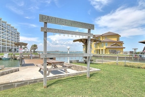 A wooden sign with 'Bay Tree' and 'Port Aransas, TX' along with a phone number. - Bright, spacious studio with balcony, king-size bed plus Murphy bed, full kitche (Port Aransas)