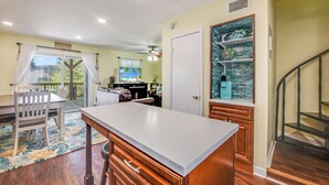 A spacious kitchen with a large island, wooden cabinets, and a view of the outdoors. - Bay Tree B11/12 offers a top notch location near the community pool, lighted fis (Port Aransas)