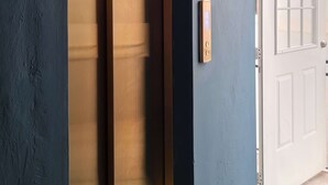 A room with a sliding door, a white door, and a light switch on the wall. - w* | Premium 1BR in Casco Antiguo (Panamá)