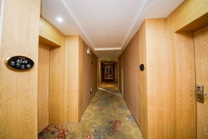 A hotel hallway with wooden walls and a carpeted floor. - Taoyuan Supreme Hotel (Taoyuan)