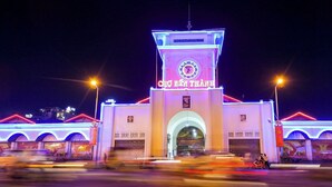 A building with a clock tower, illuminated signage, and arched entrances. - Saigon Central Hotel (Ho Chi Minh City)