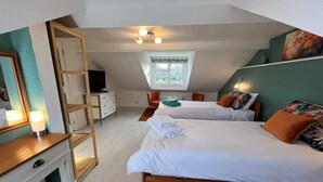 A bedroom with two beds, a desk, a TV, and a window. - The Lodge, South Cotswolds, contemporary rural home, Spa Pool, views, parking (Chippenham)