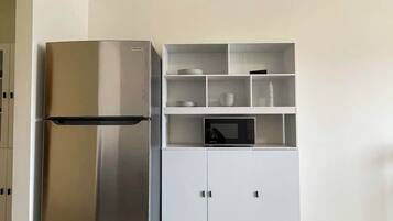 Fridge, microwave, coffee/tea maker, cookware/dishes/utensils