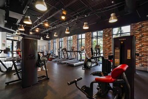 A gym with treadmills, weight machines, and a Cybex machine.