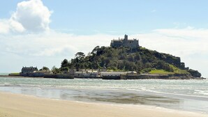 A coastal castle on a hill with a beach in the foreground. - 2 bedroom accommodation in Madron, near Penzance (Madron, near Penzance)