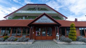 A two-story building with a sign reading "BABIC RESTORAN" at the entrance. - Hotel Babic (Plitvicka Jezera)