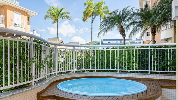 A swimming pool with a wooden deck and a white fence. - 350m from the Beach | Pool | Barbecue #IA20 (Florianópolis)