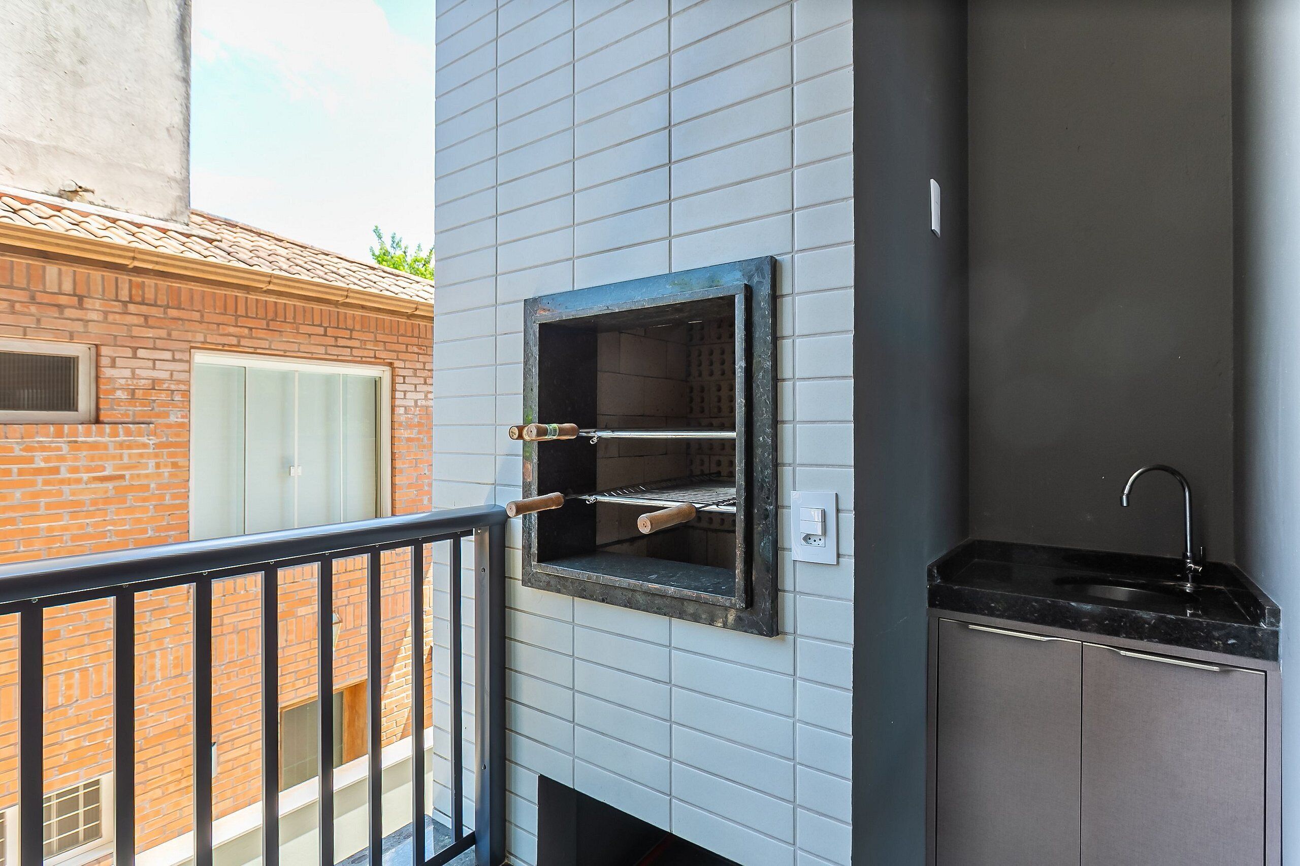 A small kitchen with a built-in oven and a sink.