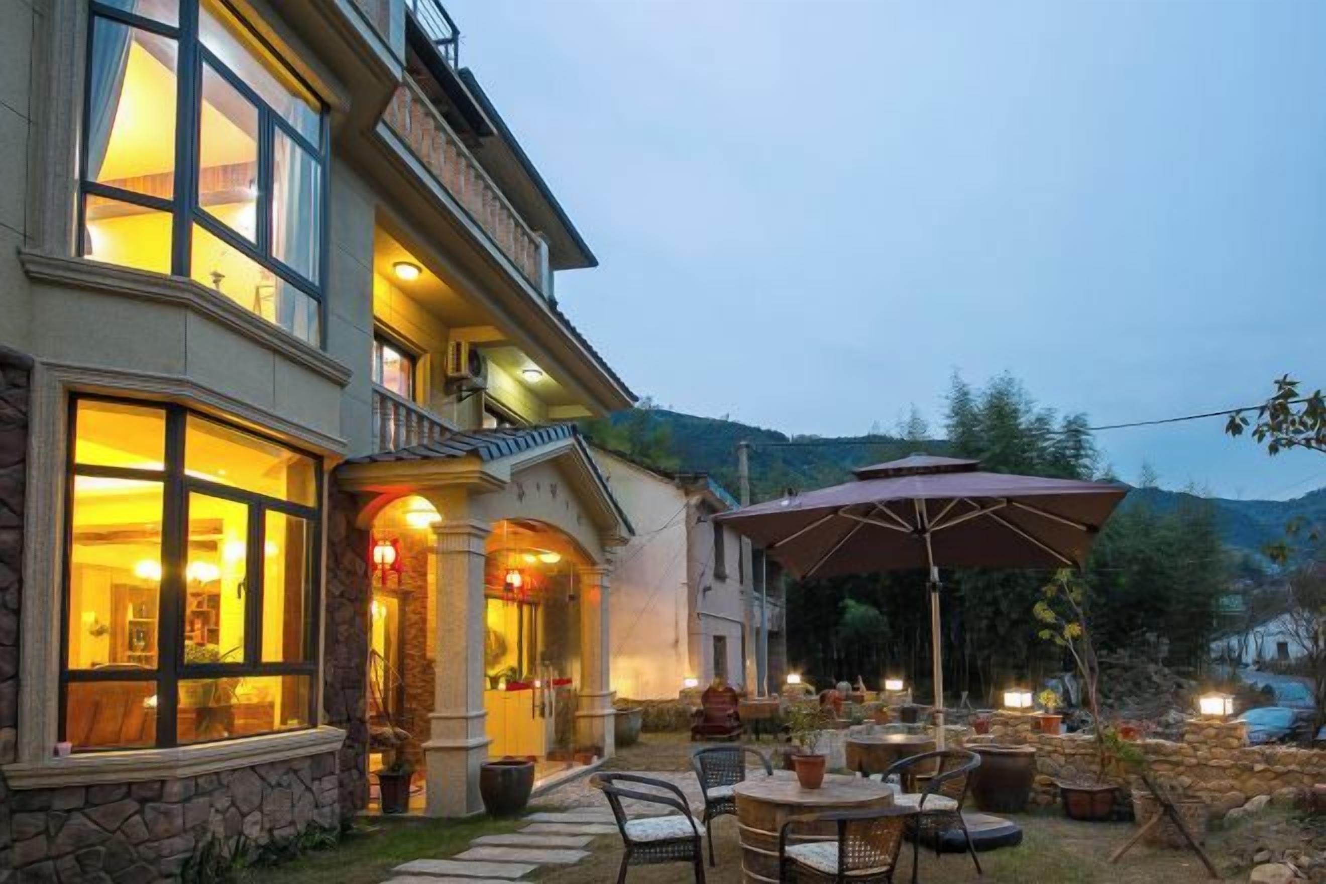 A building with outdoor seating and a large umbrella.