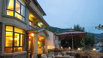 A building with outdoor seating and a large umbrella.