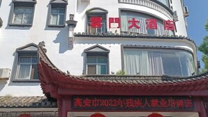 Un hôtel à l’architecture chinoise traditionnelle, caractérisé par un toit incurvé et de nombreuses fenêtres.