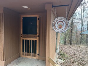 A wooden door with a glass panel and a sign reading "PIONEER COFFEE". - Entire Campground - All 10 Cabins for Events and Overnights. Up to 40 Guests. (Hatfield)
