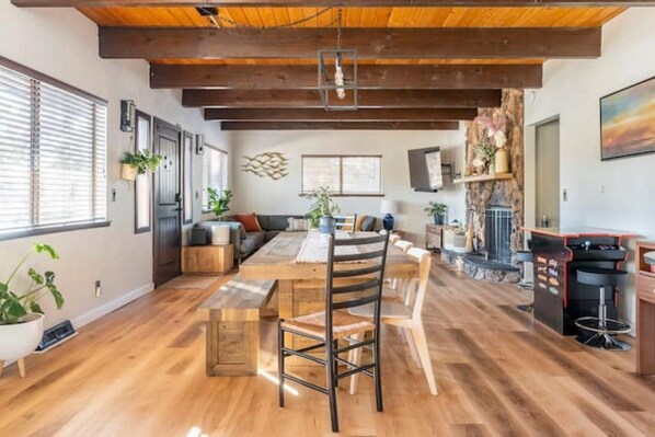 Cozy dining area with a fireplace, large dining table, and comfortable seating.