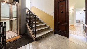 Una escala amb una porta de fusta i una barana metàl·lica.
