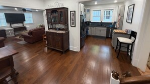 A modern kitchen with a built-in oven, a sink, and a dining area with a wooden table and chairs. - Old Town Charmer Large all new renovation, walk to USM, Zoo and new Water Park! (Hattiesburg)