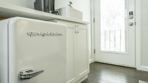 A white refrigerator with a metallic handle and the word "Frigidaire" on the door.