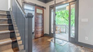 A staircase with a wooden finish and a carpeted landing. - The Mont Rose - Walkable to 12 South (Nashville)