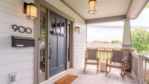 A porch with a mailbox, a door, and two chairs. - The Mont Rose - Walkable to 12 South (Nashville)