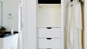 A white wardrobe with four drawers and a hanging space on the right. - Cozy MEX-style apartment just steps from Reforma. (Ciudad de México)