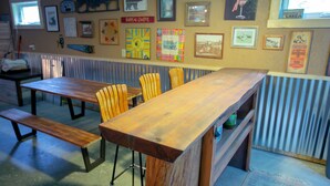 A restaurant with wooden tables and chairs, a bench, and various framed pictures on the walls. - Smith Lake Cabin with Game Room (Marcell)