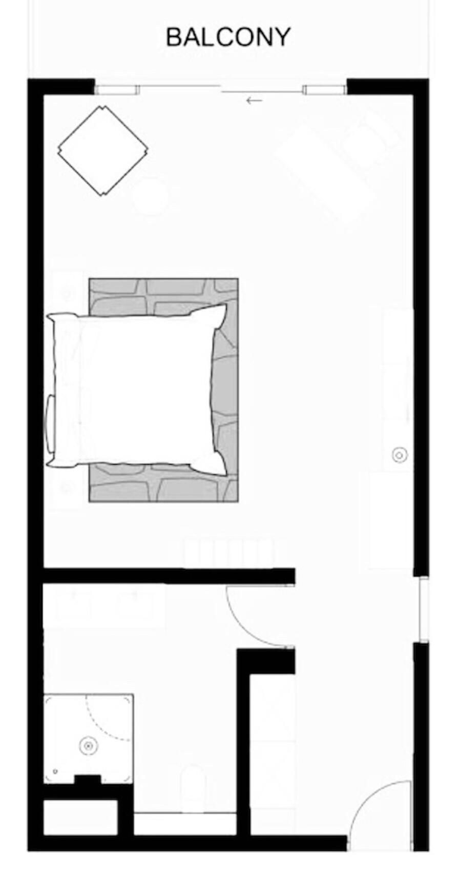 A floor plan of a property with a balcony, a living area with a fireplace, and a bathroom.