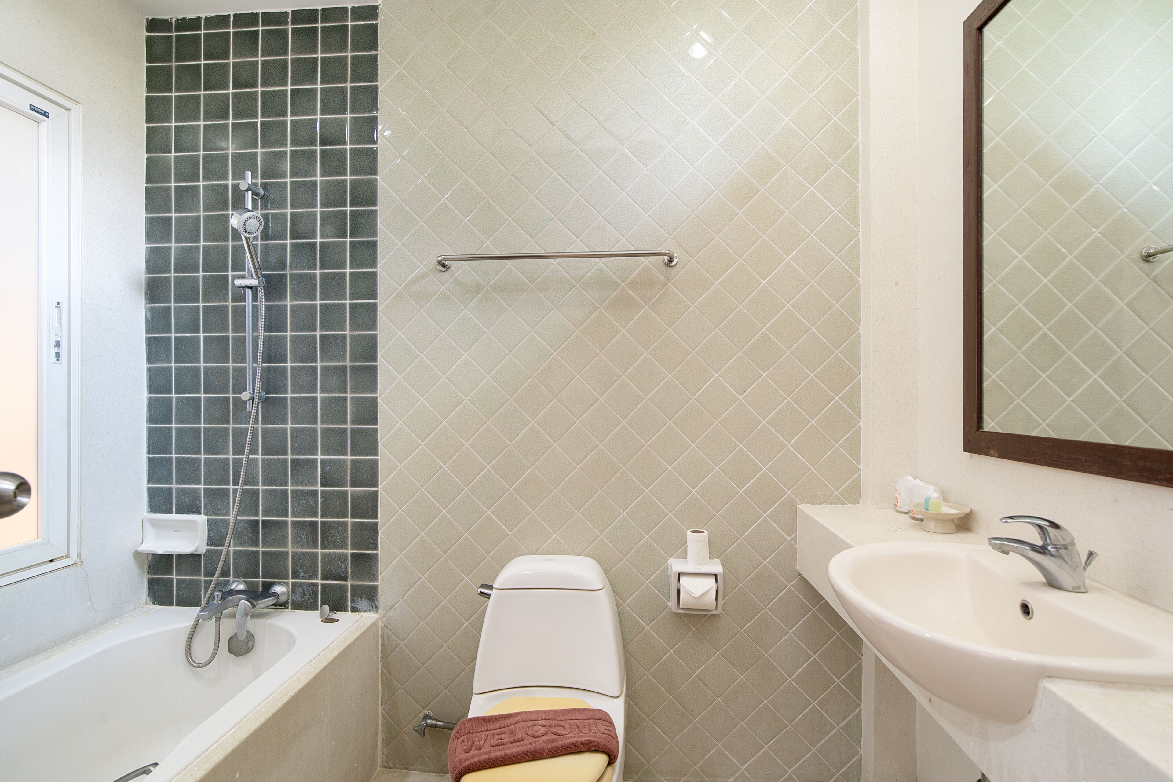 A bathroom with a bathtub, toilet, and sink.
