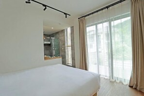 A modern bedroom with a large bed, a built-in window, and a view of the outdoors. - Wonder Villa (Deqing)