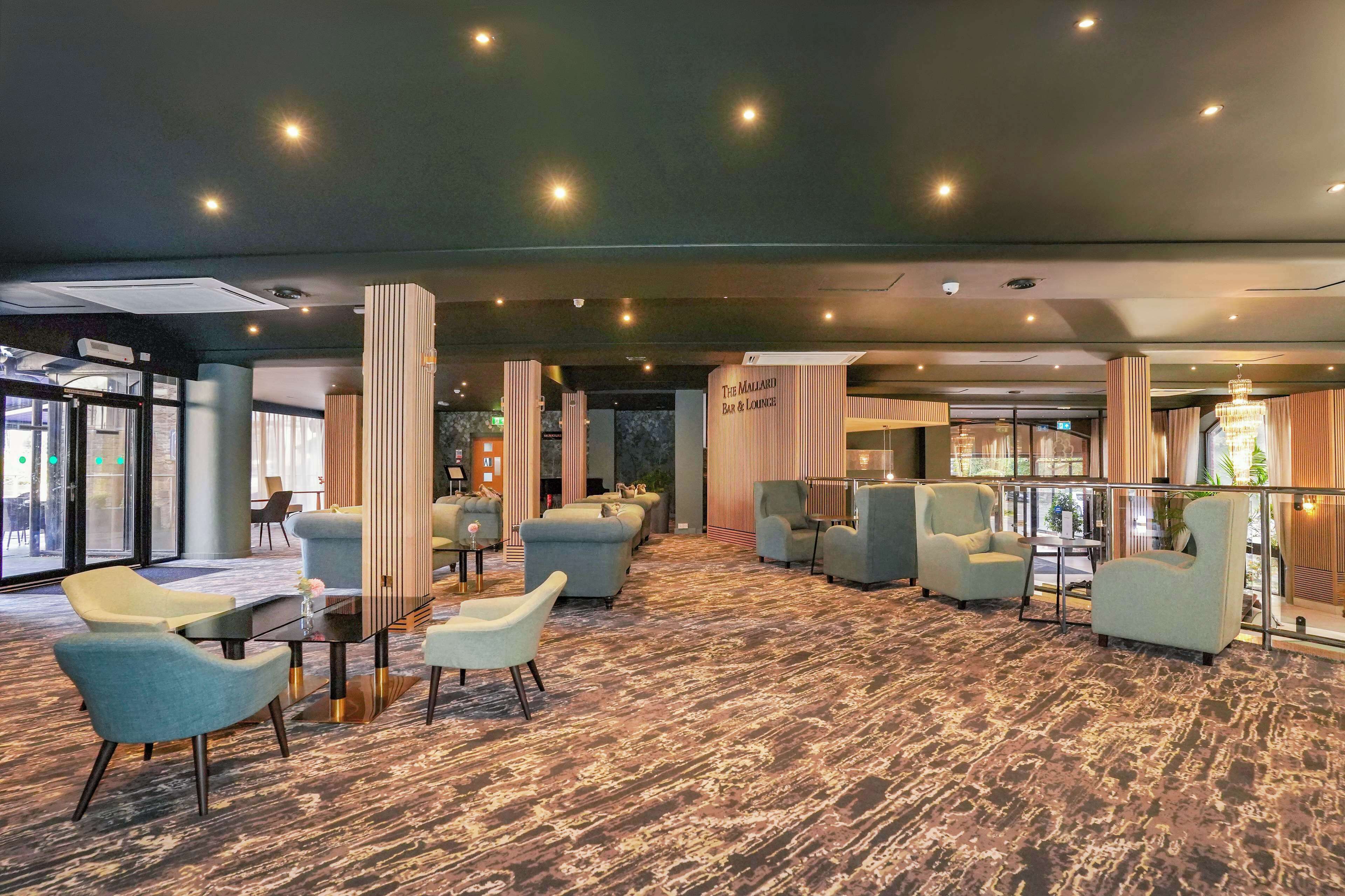 A modern lounge area with seating arrangements and a bar/lounge section.