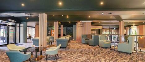 A modern lounge area with seating arrangements and a bar/lounge section.