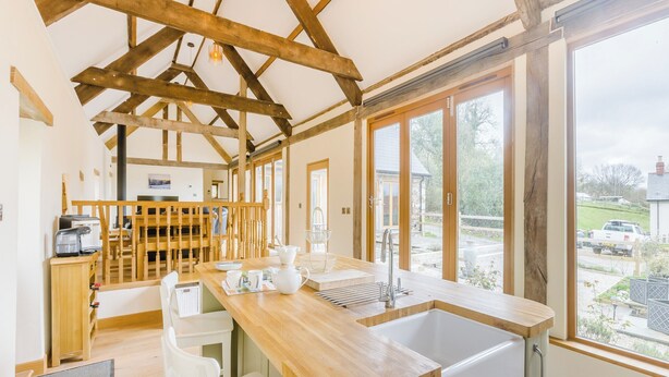 A modern kitchen with a wooden countertop, a sink, and a view of the outside. - 3 bedroom accommodation in Rackenford, near Tiverton (Rackenford, near Tiverton)