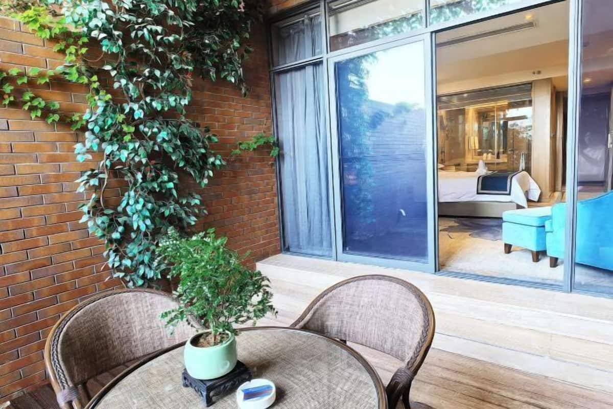 A modern room with a large sliding glass door leading to a balcony with a view of the interior.