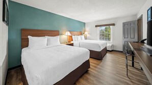 A hotel room with two beds, a desk, a TV, and a window. - MainStay Suites Foxboro – Mansfield (Foxborough)