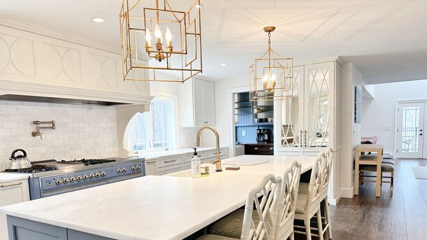 A modern kitchen with a large island, white cabinetry, and a gas stove. - Spacious Home Near Wallis Sands Beach in Rye NH (Rye)