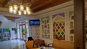 A spacious lobby with a polished floor, a chess table, and traditional decor. - Nostalgia boutique hotel (Bukhara)