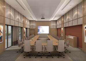 A conference room with a long table, chairs, a projector screen, and a large window. - Holiday Inn & Suites Kocaeli Dilovası Gulf View by IHG (Dilovasi)