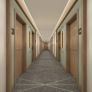 A hotel hallway with doors numbered 12 and 20, carpeted flooring, and a ceiling with recessed lighting. - Holiday Inn & Suites Kocaeli - Dilovasi Gulf View by IHG (Dilovasi)