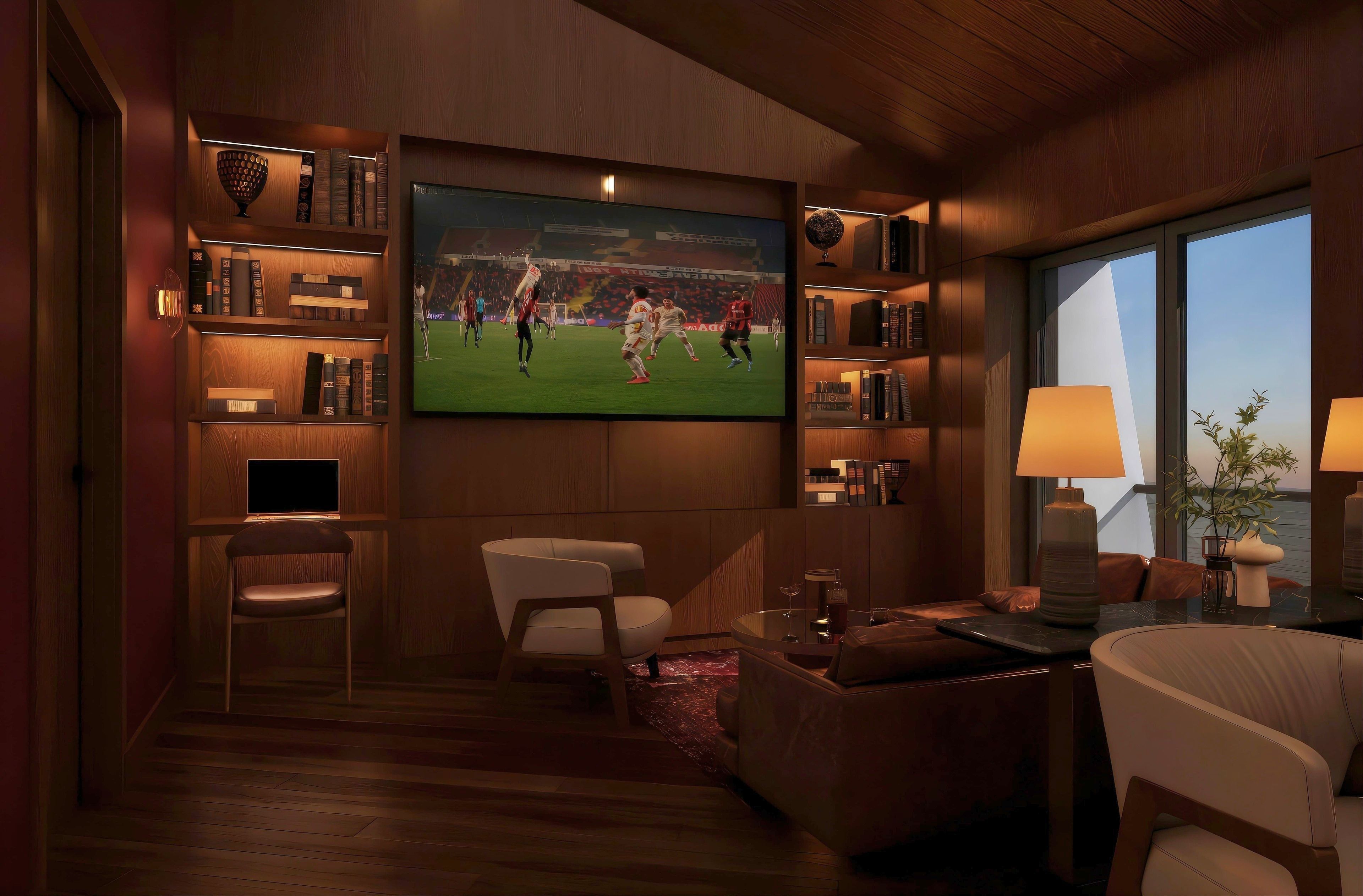 A modern living room with a flat-screen TV mounted on the wall, a bookshelf, a comfortable seating area with a sofa and armchairs, and a large window providing a view of the outdoors.