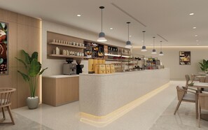A modern coffee shop interior with a counter, seating area, and various coffee-related items on display. - Holiday Inn Hotel And Suites Kocaeli Dilovasi Gulf View by IHG (Dilovasi)