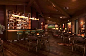 A bar area with multiple seating options, including bar stools and tables, and a television screen displaying a sports event. - Holiday Inn Hotel And Suites Kocaeli Dilovasi Gulf View by IHG (Dilovasi)
