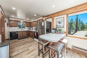 Enjoy a meal with a view from the kitchen's island, where you can cook and dine while taking in the surrounding forest scenery.
