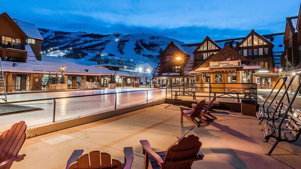 A snow-covered outdoor area with wooden buildings and chairs. - Lodge at Mtn Village A212 | Ski-In/Out | Plaza View | PCMR | Pool | Hot Tub (Park City)