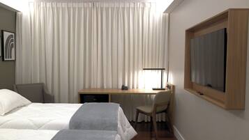 A hotel room with two beds, a desk, a chair, a television, and a window with curtains.