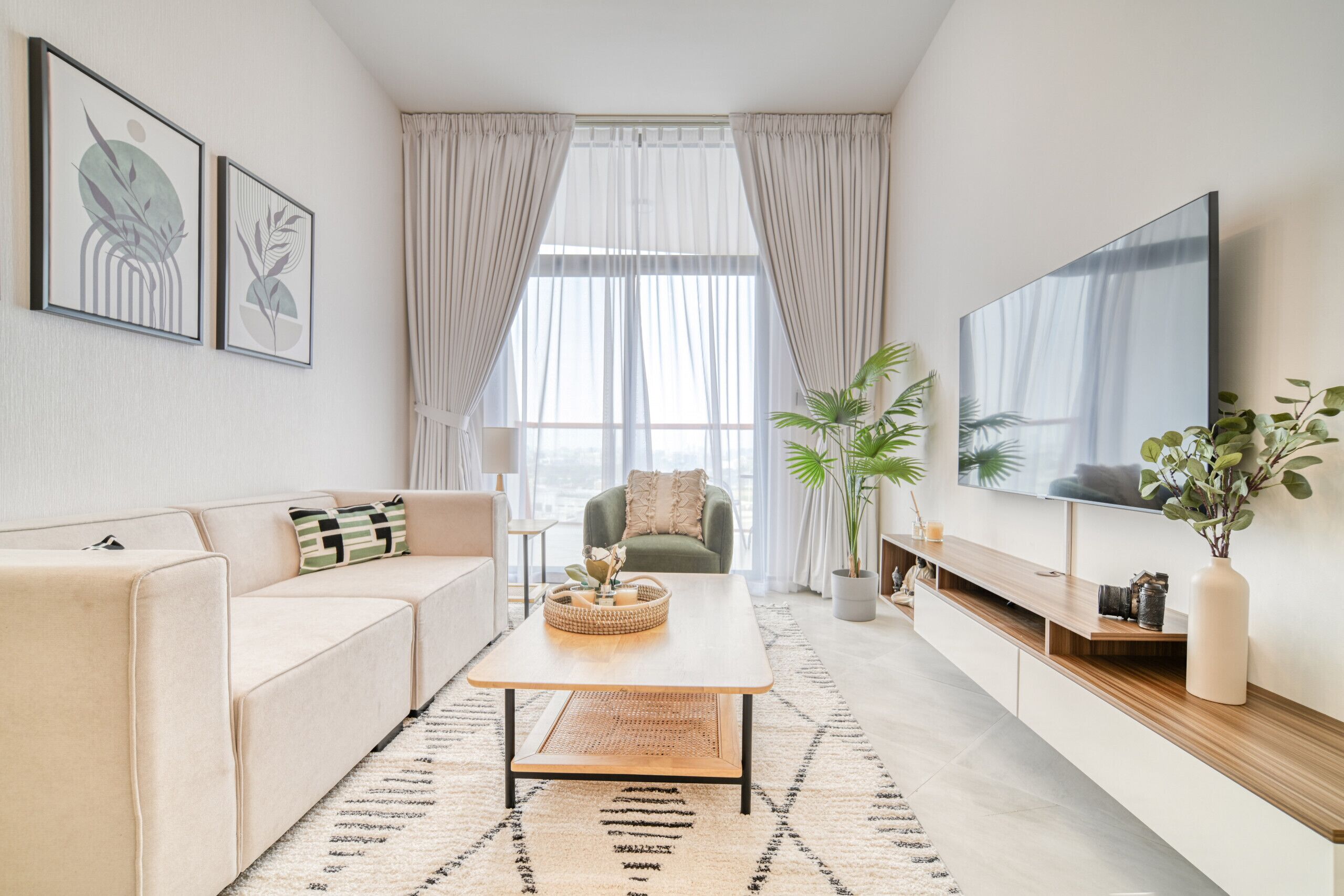 A modern living room with a sofa, coffee table, and TV.