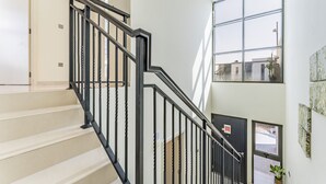 A staircase with black railings leading to an upper floor. - Flawless 3BR Townhouse with Asst's Rm at DAMAC Hills 2 Amazonia by Deluxe Holiday Homes (Dubai)