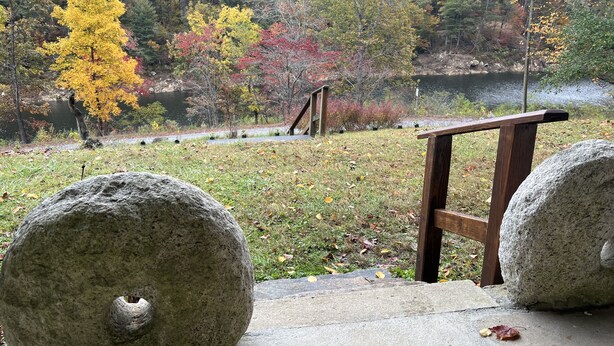 A stone pathway leading to a wooden viewing platform overlooking a lake surrounded by autumn-colored trees. - Cabin with private lake access on Cedar Cliff Lake (Tuckasegee)