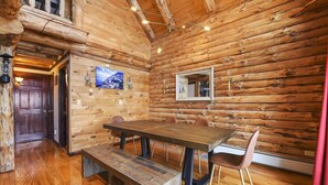 A wooden interior with a dining table, chairs, and a bench. - Berkshire Mountain Top Chalet (North Adams)